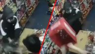 Watch cashier in a Kragujevac store chase robber out by beating him with a crate (VIDEO)