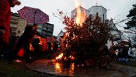 Maske, kišobrani i vernici koje greje iskra radosti: Ovako je izgledalo paljenje badnjaka u Beogradu