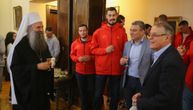 Patriarch Porfirije hosts Red Star and is gifted a red and white jersey with his name on it