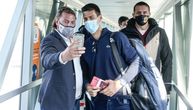 First photos of Novak in Belgrade: Airport staff take selfies, fans wave Serbian and Russian flags