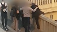 Video of new suicide attempt in central Belgrade: Man tries to jump over underpass fence, people hold him back