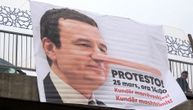 Image showing Kurti with Pinocchio nose and announcement of protest: Banners displayed all over Pristina