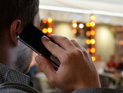 čovek razgovara mobilnim telefonom