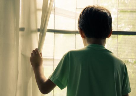 Dečak gleda kroz prozor
