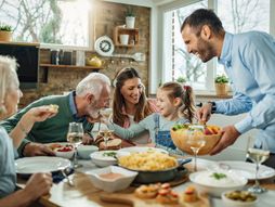 Multi-generation family gathering around dining table